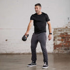 Unconditional Active Warlock Long Jogger trackpants in black with elastic waistband and tapered fit, designed for active wear and comfort.