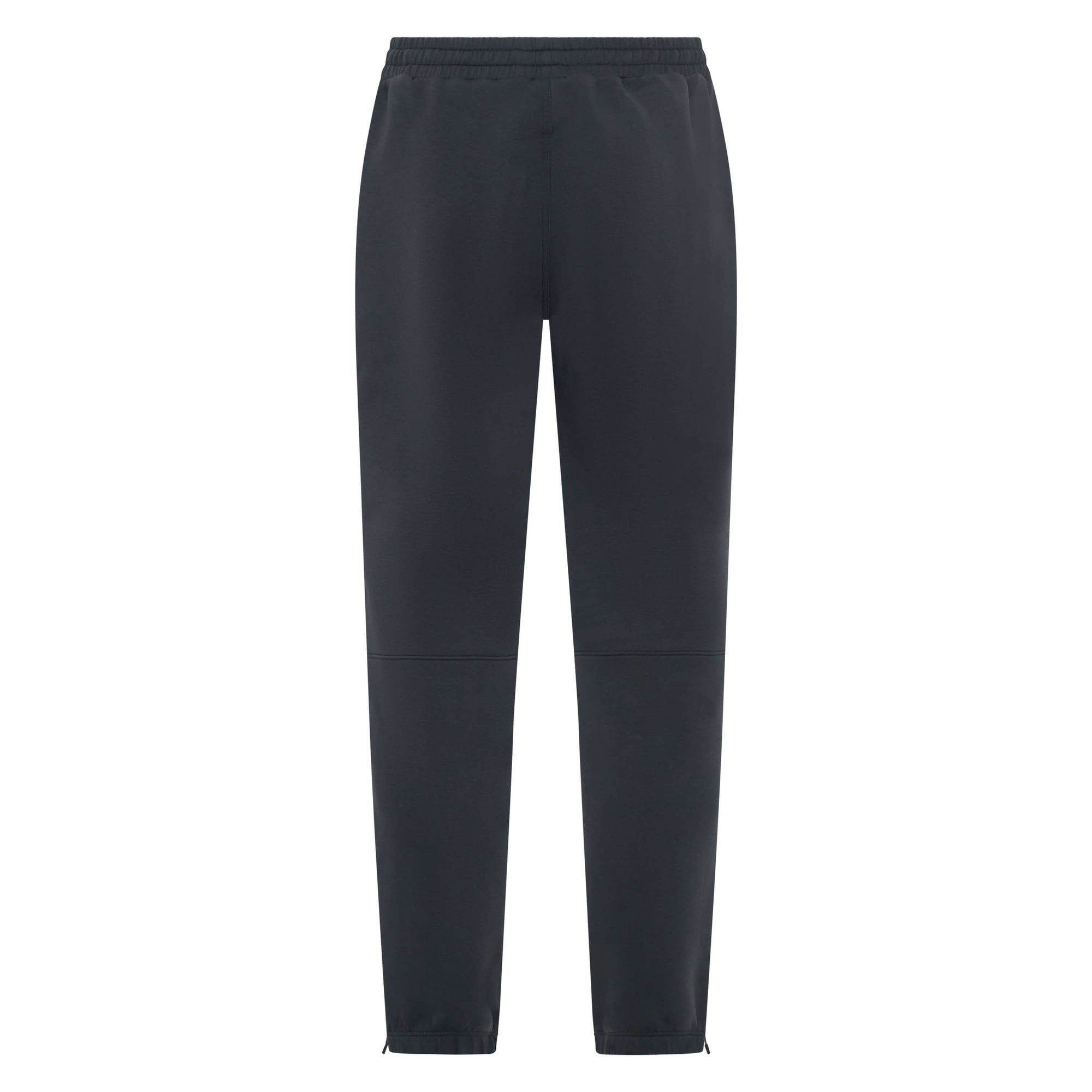 Dark charcoal Unconditional Active Onslaught Everywhere track pants laid flat, showing elastic waistband and tapered fit.
