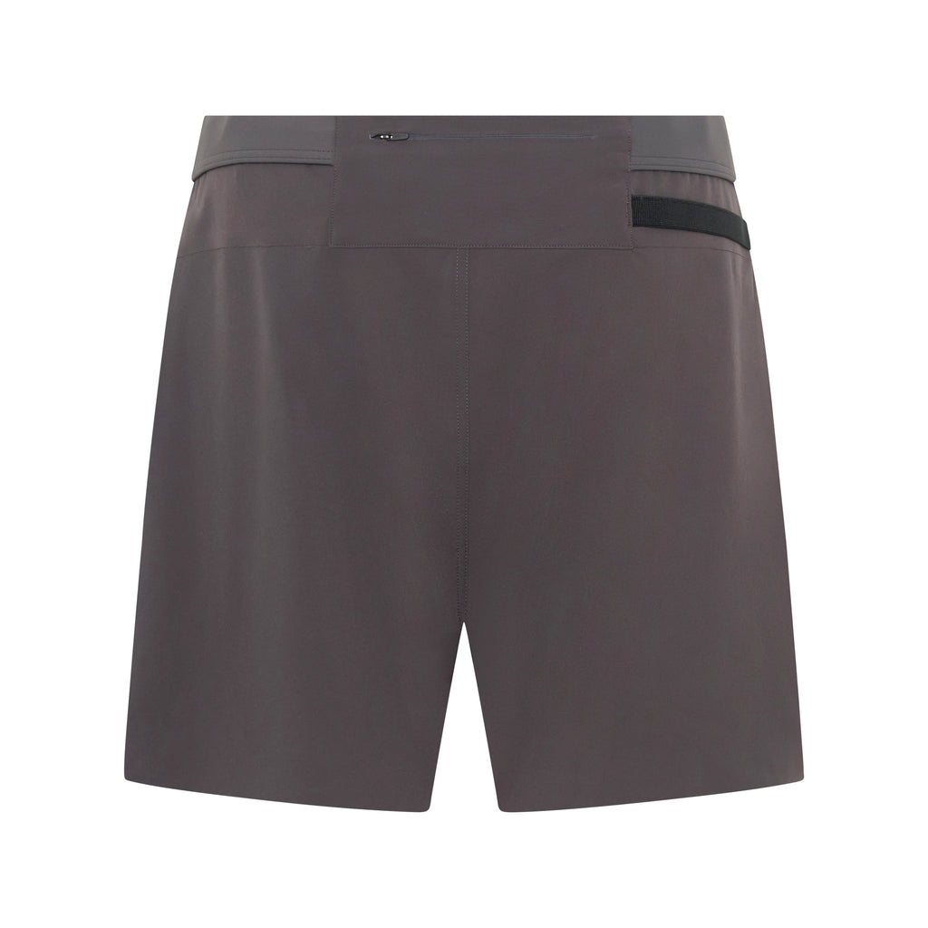 Unconditional Active Taskmaster 5-inch dark charcoal session shorts laid flat, showcasing lightweight breathable fabric and elastic waistband.
